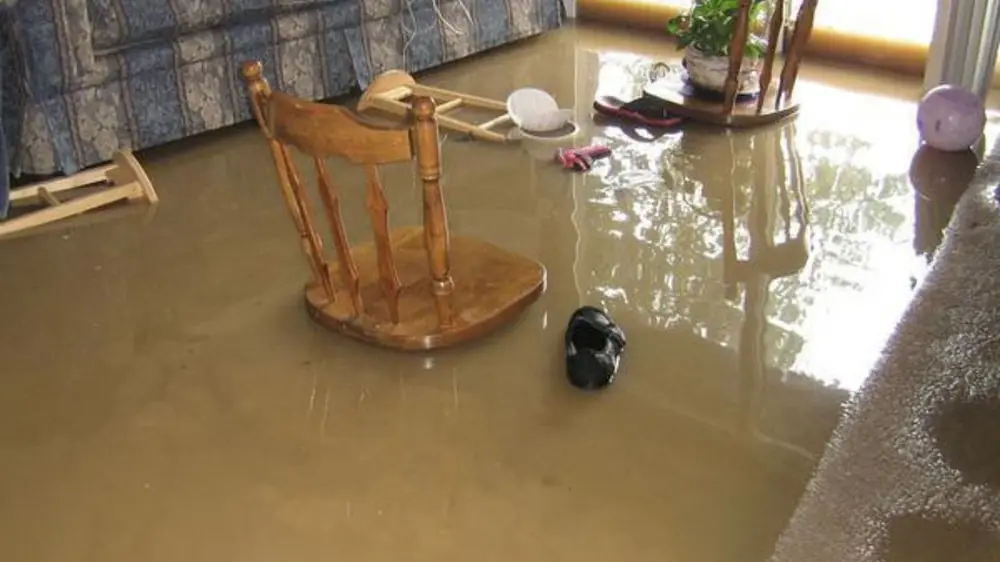 Flooded room with a wooden chair standing in water