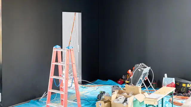 Room prepared for work with ladders, tarps and drying equipment